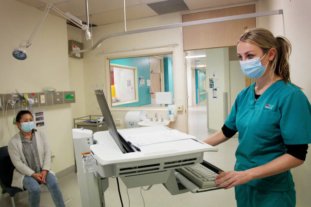 A doctor speaks with a patient during triage at the St George Hospital in Sydney, Australia, on May 15, 2020. (Lisa Maree Williams/Getty Images)