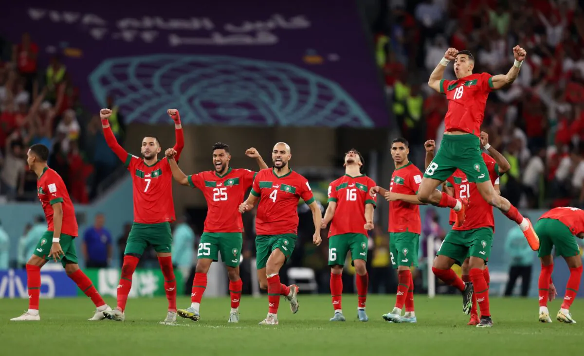 Morocco players celebrate their victory through the penalty shootout after the FIFA World Cup Qatar 2022 Round of 16 match between Morocco and Spain at Education City Stadium in Al Rayyan, Qatar, on Dec. 6, 2022. (Julian Finney/Getty Images)
