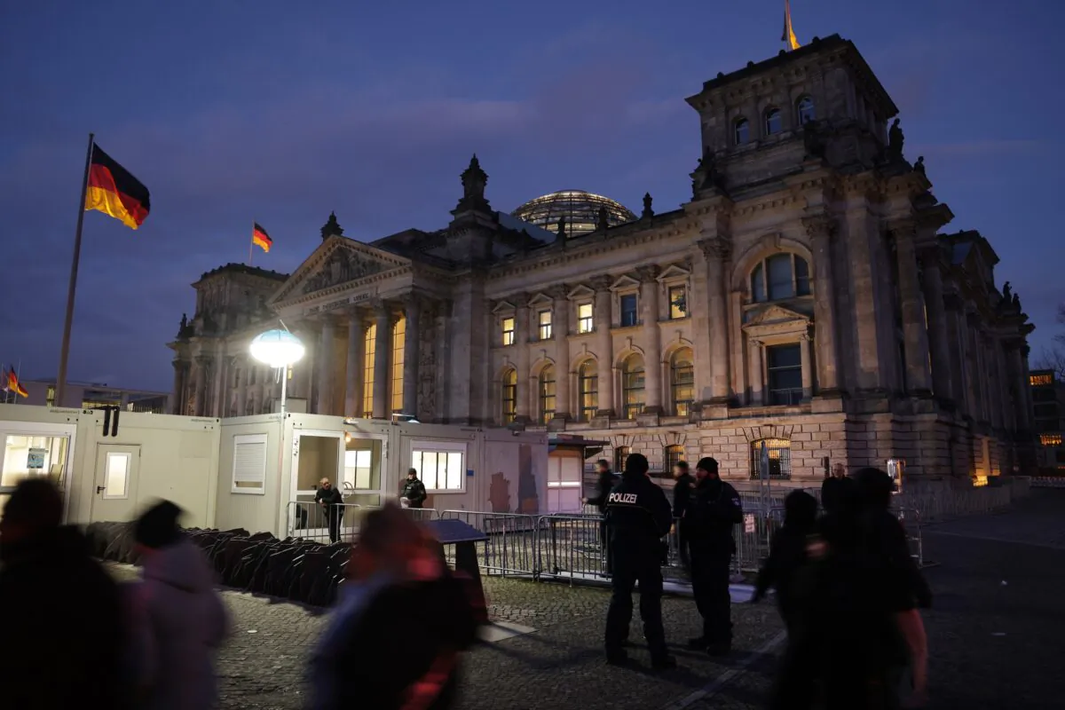 Police and visitors stand outside the Reichstag, seat of the Bundestag, Germany's parliament, at dusk on the day police conducted nationwide raids against a suspected insurrectionist group in Berlin on Dec. 7, 2022. (Sean Gallup/Getty Images)