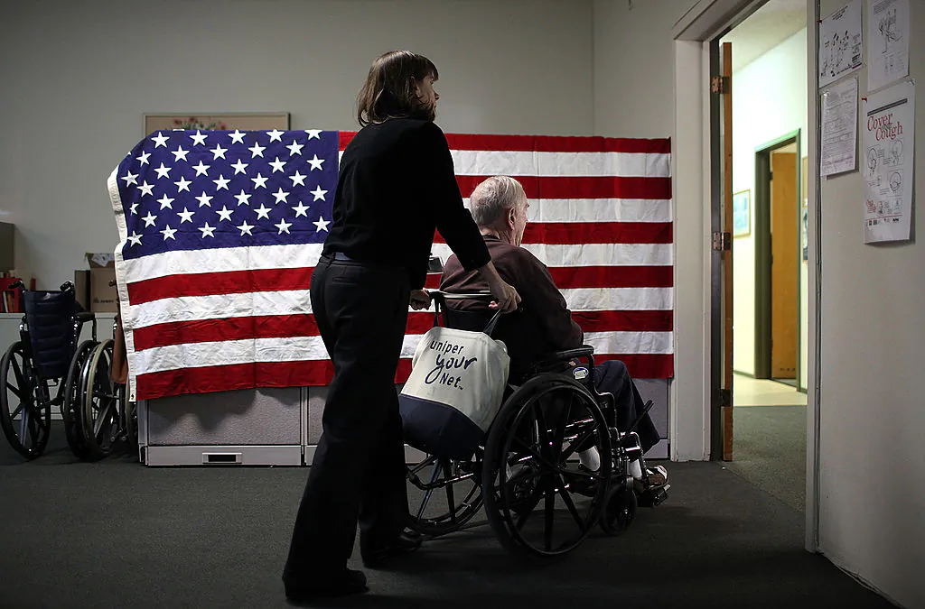 A woman pushes Fred Lear in a wheelchair after he had a physical therapy session at the Lifelong Medical Marin Adult Day Health Care Center in Novato, Calif., on Feb. 10, 2011. (Justin Sullivan/Getty Images)