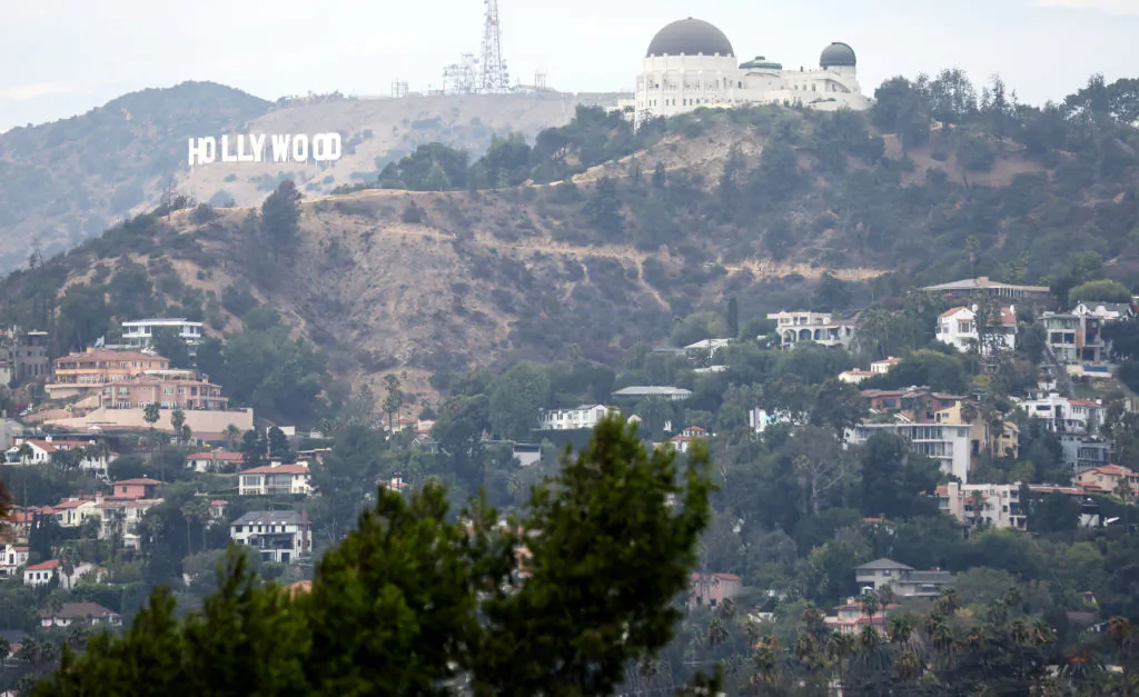 Homes stand beneath Griffith Observatory and the Hollywood sign in Los Angeles on Aug. 4, 2022. (Mario Tama/Getty Images)