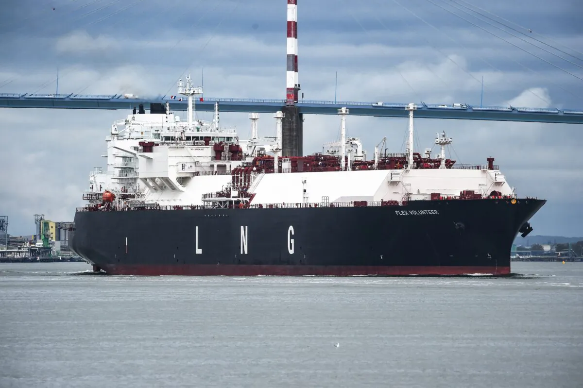 The LNG (liquefied natural gas) tanker Flex Volunteer, sailing under the flag of the Marshall Islands, cruises near the Saint-Nazaire bridge over the Loire estuary, as it leaves the dock of the LNG Terminal of Montoir-de-Bretagne, near Saint-Nazaire, western France, on April 12, 2022. (Sebastien Salom-Gomis/AFP via Getty Images)