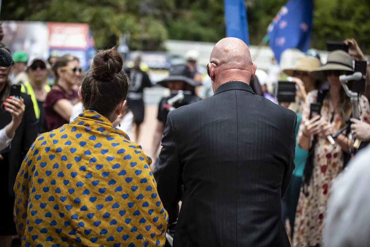 The mother and father of a four-month-old baby that urgently needs a heart operation leave the High Court in Auckland, New Zealand, Tuesday, Dec. 6, 2022. The court on Wednesday, Dec. 7, 2022, ruled against the family who had refused blood transfusions for their baby son unless the blood came from donors who hadn't been vaccinated against COVID-19. (Michael Craig/New Zealand Herald via AP)