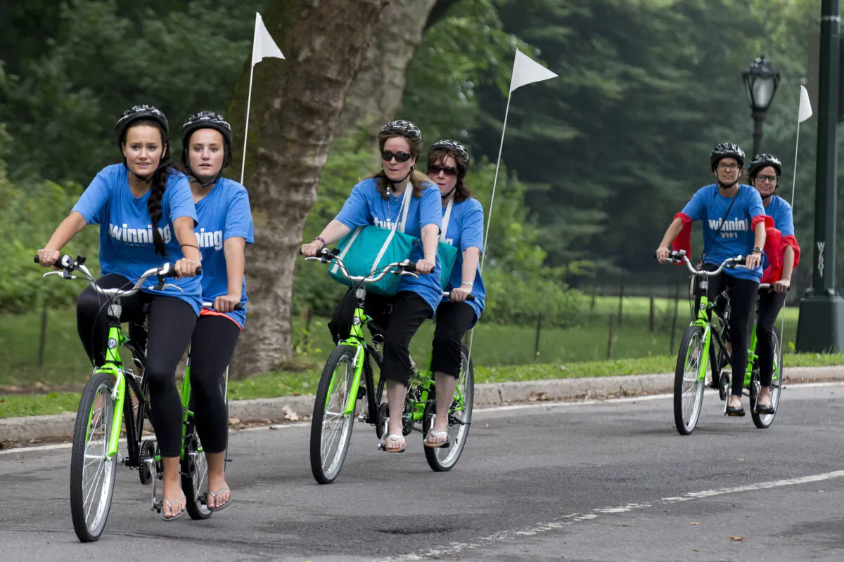 Sets of twins ride on tandem bicycles in New York's Central Park on July 15, 2015. (Brendan McDermid/Reuters)