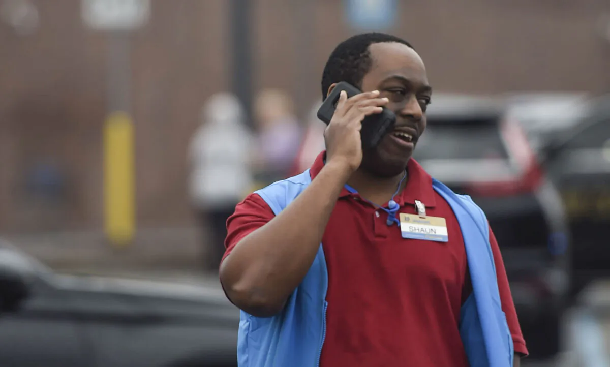 A Walmart employee speaks on a phone outside a Walmart store in Kennesaw, Ga., on Dec. 7, 2022. (Mike Stewart/AP Photo)