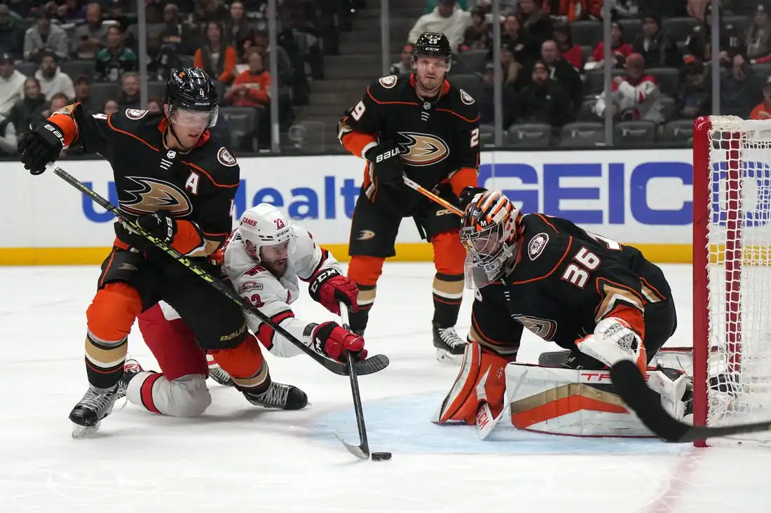 Anaheim Ducks defender Cam Fowler (4), and goalie John Gibson (36) defend Carolina Hurricanes winger Stefan Noesen (23), at NHL hockey game in Anaheim, Calif., on Dec. 6, 2022. (Field Level Media)