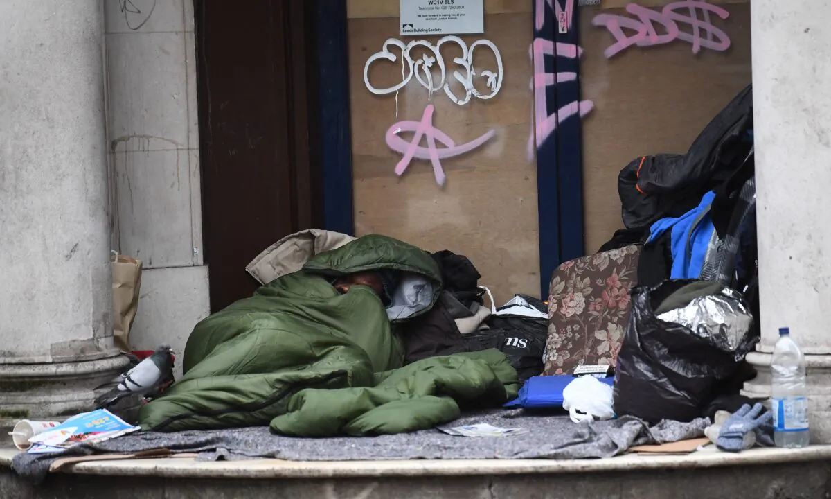 A homeless man sleeping in the doorway of a closed down branch of the Leeds Building Society on Kingsway, Holborn, London, on Jan. 28, 2020.
(Victoria Jones/PA Media)