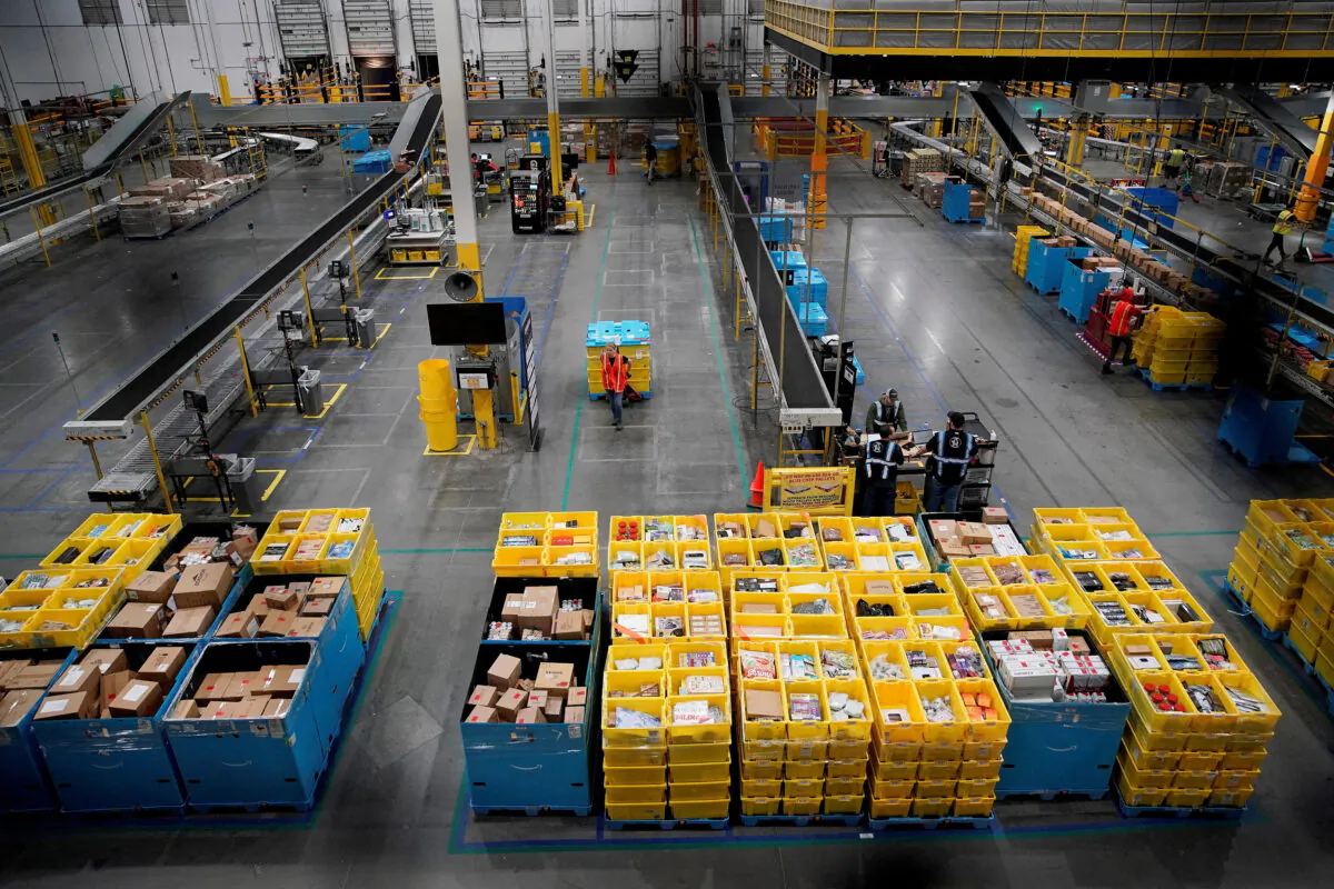 Workers select and pack items during Cyber Monday at the Amazon fulfilment center in Robbinsville Township, N.J., on Nov. 28, 2022. (Eduardo Munoz/Reuters)