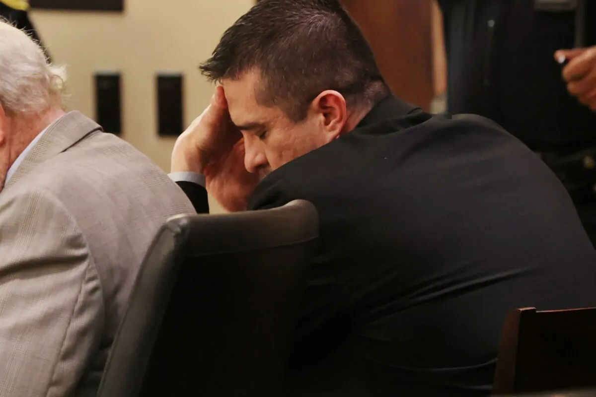 Former U.S. Border Patrol supervisor Juan David Ortiz reacts as recorder jail phone calls to his wife, Daniella, are played outside the presence of the jury during his capital murder trial at the Cadena-Reeves Justice Center in San Antonio, Texas, on Dec. 6, 2022. (Jerry Lara/The San Antonio Express-News via AP)