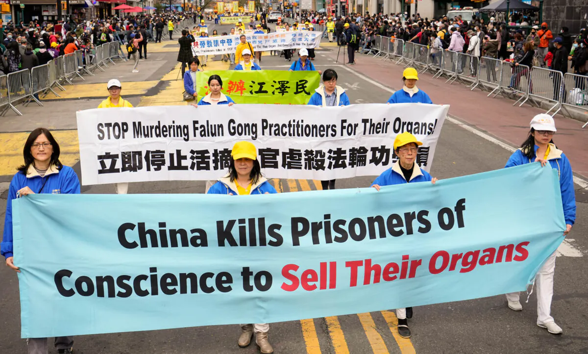 Falun Gong practitioners take part in a march to raise awareness about the Chinese regime's brutal persecution of the spiritual practice, including forced organ harvesting, in New York on May 13, 2022. (Larry Dye/The Epoch Times)