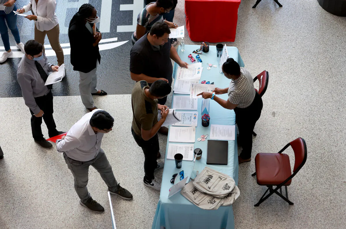 Angela Perry (R), a recruiter for Cox Media Group, helps people looking for work during the Mega Job Fair held at the FLA Live Arena in Sunrise, Fla., on June 23, 2022. (Joe Raedle/Getty Images)