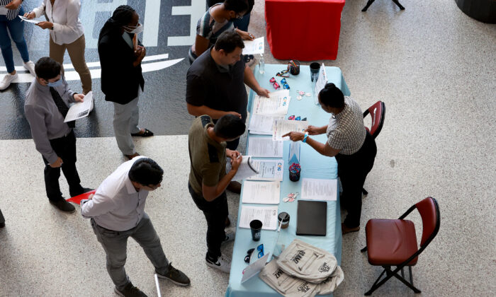 Angela Perry (R), a recruiter for Cox Media Group, helps people looking for work during the Mega Job Fair held at the FLA Live Arena in Sunrise, Fla., on June 23, 2022. (Joe Raedle/Getty Images)