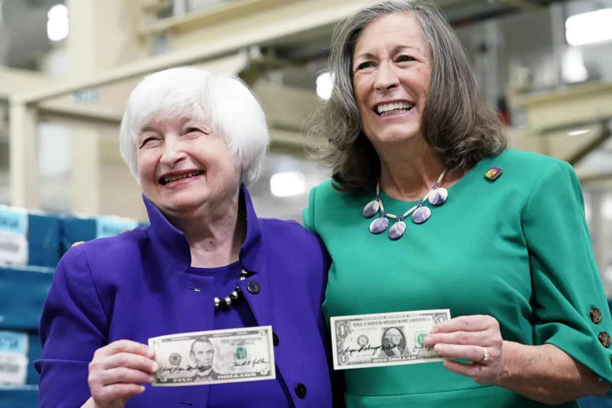 Secretary of the Treasury Janet Yellen, (L), and Treasurer of the United States Chief Lynn Malerba show of money they autographed during a tour of the Bureau of Engraving and Printing's (BEP) Western Currency Facility in Fort Worth, Texas, on Dec. 8, 2022. (LM Otero/AP Photo)