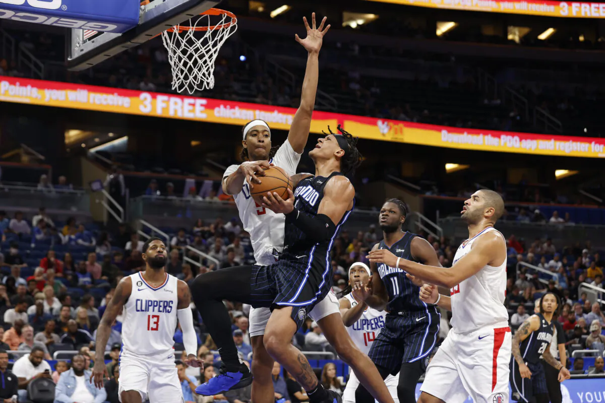 Orlando Magic forward Paolo Banchero drives to the basket under pressure from Los Angeles Clippers guard Luke Kennard during the first half of an NBA basketball game in Orlando, Fla., on Dec. 7, 2022. (Scott Audette/AP Photo)