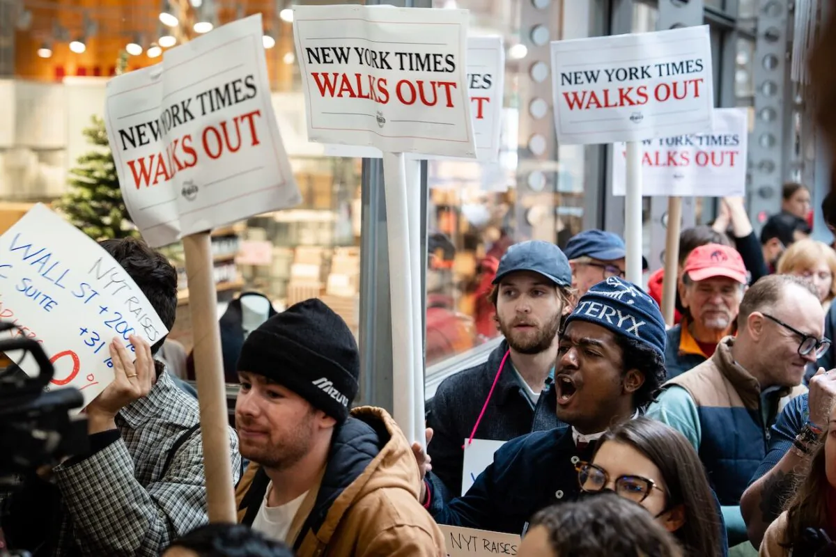 Reporters, editors, and other employees at The New York Times take part in a walkout demanding increases in salaries and benefits at the New York Times building in New York City on Dec. 8, 2022.(Samira Bouaou/The Epoch Times)