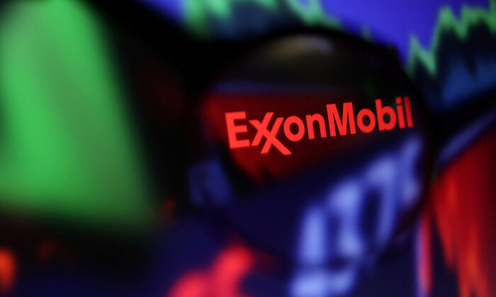 Exxon Mobil logo and stock graph are seen through a magnifier displayed in this illustration taken on Sept. 4, 2022. (Dado Ruvic/Illustration/Reuters)