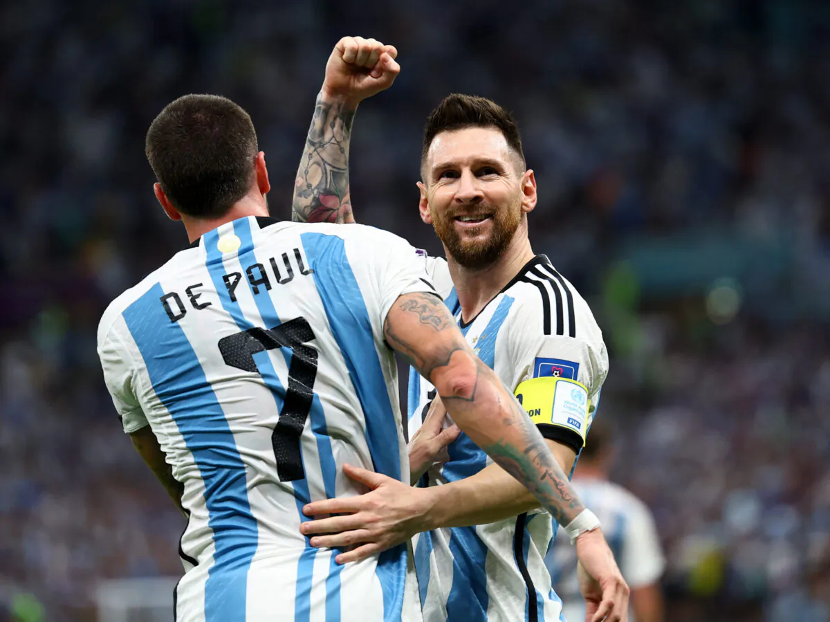 Argentina's Lionel Messi and Rodrigo De Paul celebrate after Nahuel Molina scores their first goal at the World Cup quarterfinal soccer match between the Netherlands and Argentina at the Lusail Stadium in Lusail, Qatar, on Dec. 9, 2022. (Kai Pfaffenbach/Reuters)