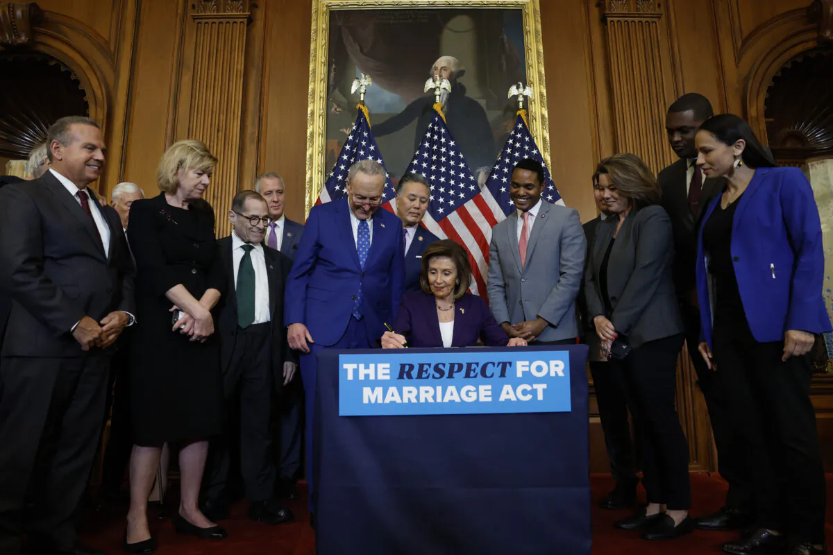House Speaker Nancy Pelosi (D-Calif.) participates in a bill enrollment ceremony alongside Senate Majority Leader Chuck Schumer (D-N.Y.) and a bipartisan group of senators and representatives for the "Respect For Marriage" Act at the U.S. Capitol Building in Washington on Dec. 8, 2022. (Anna Moneymaker/Getty Images)