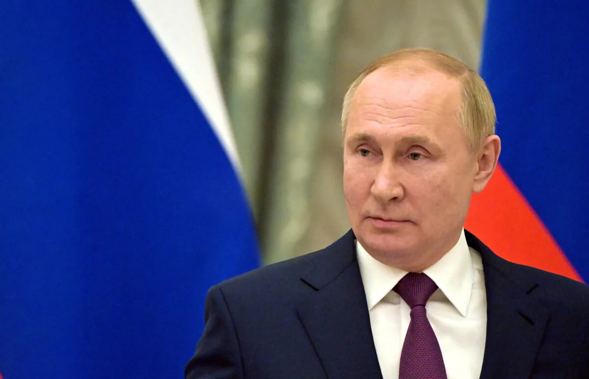 Russian President Vladimir Putin attends a joint news conference with German Chancellor Olaf Scholz in Moscow on Feb. 15, 2022. (Sputnik/Sergey Guneev/Kremlin via Reuters)