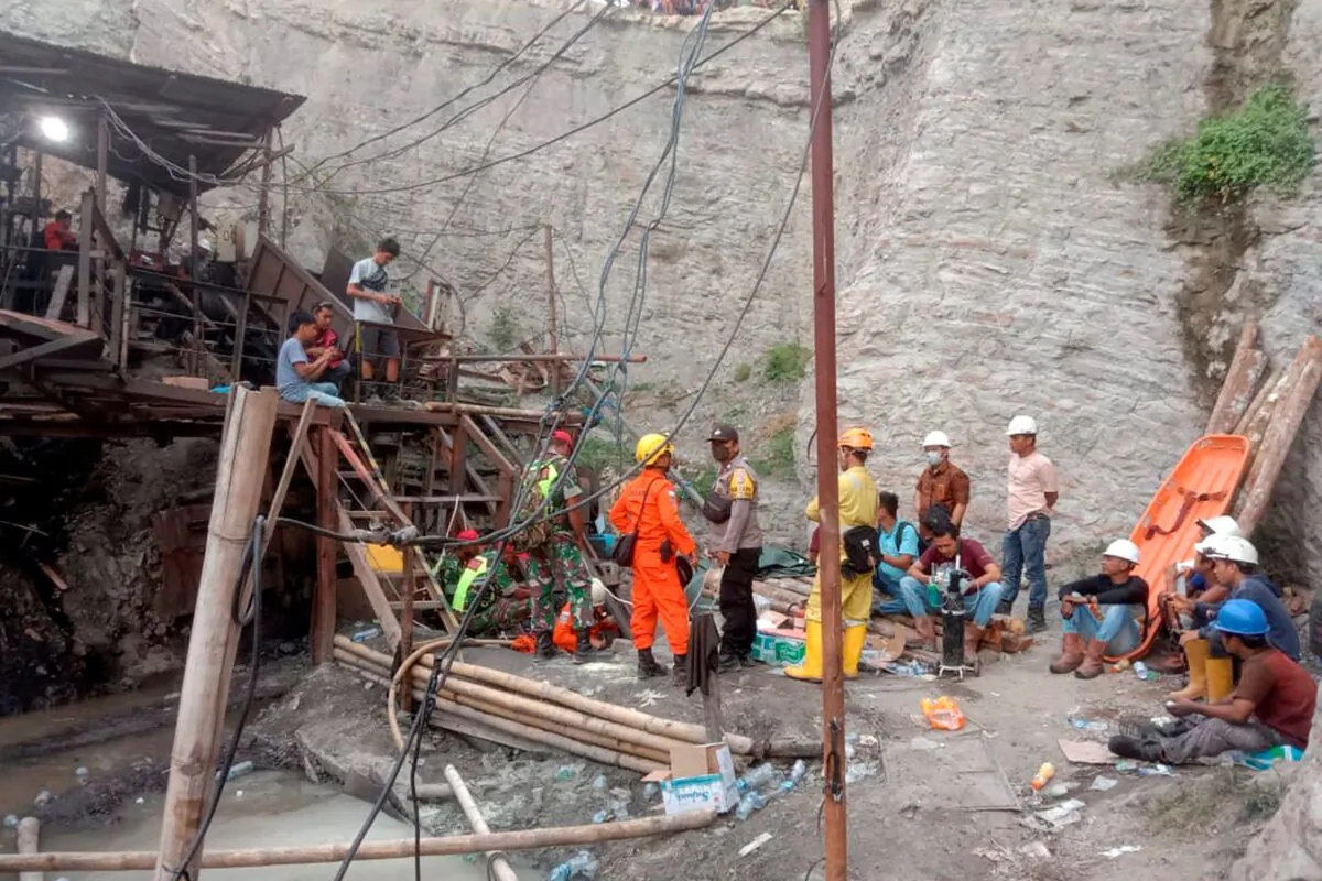 Rescuers and workers wait at the entrance of a coal mine during the search for victims after an explosion in Sawahlunto, West Sumatra, Indonesia, on Dec. 9, 2022. (Devanya Zianisa/AP Photo)