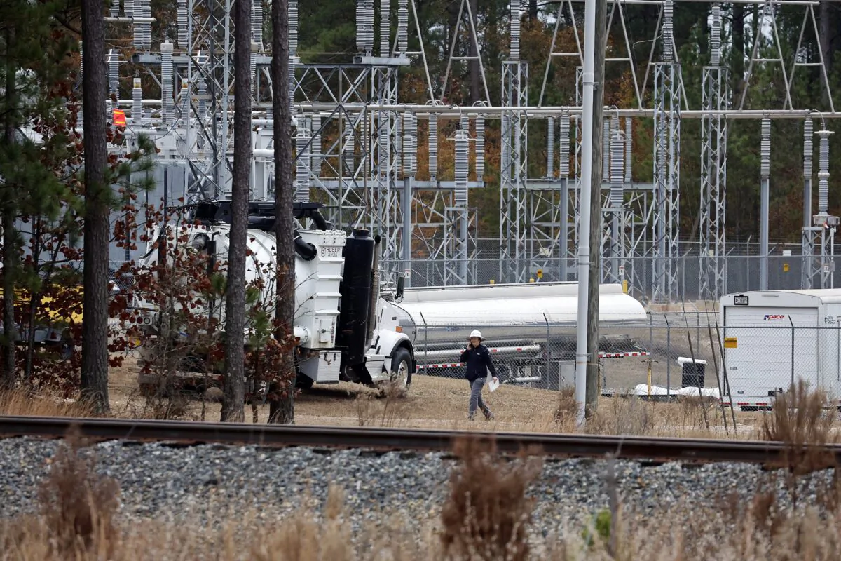 Workers work on equipment at the West End Substation, at 6910 NC Hwy 211 in West End, N.C., on Dec. 5, 2022, where a serious attack on critical infrastructure has caused a power outage to many around Southern Pines, N.C. (Karl B DeBlaker/AP Photo)