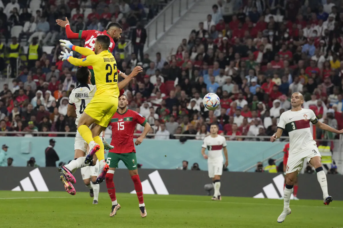 Morocco's Youssef En-Nesyri scores his side's first goal during the World Cup quarterfinal soccer match between Morocco and Portugal, at Al Thumama Stadium at Al Thumama Stadium in Doha, Qatar, on Dec. 10, 2022. (Martin Meissner/AP Photo)