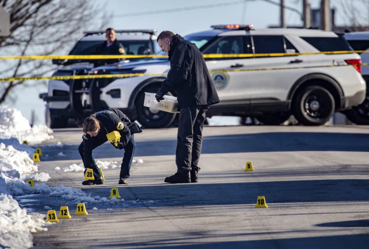 Police investigate a shooting outside of East High School in in Des Moines, Iowa, on March 7, 2022.  (Zach Boyden-Holmes/The Des Moines Register via AP)