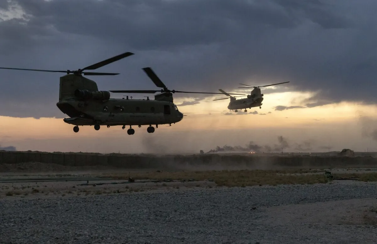 CH-47 Chinook helicopters take off while transporting troops from a remote combat outpost in northeastern Syria on May 24, 2021. (John Moore/Getty Images)