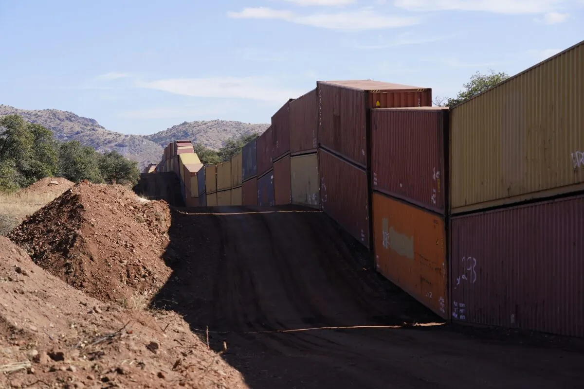 A long row of double-stacked shipping contrainers provide a new wall between the United States and Mexico in the remote section area of San Rafael Valley, Ariz., on Dec. 8, 2022. (Ross D. Franklin/AP Photo)