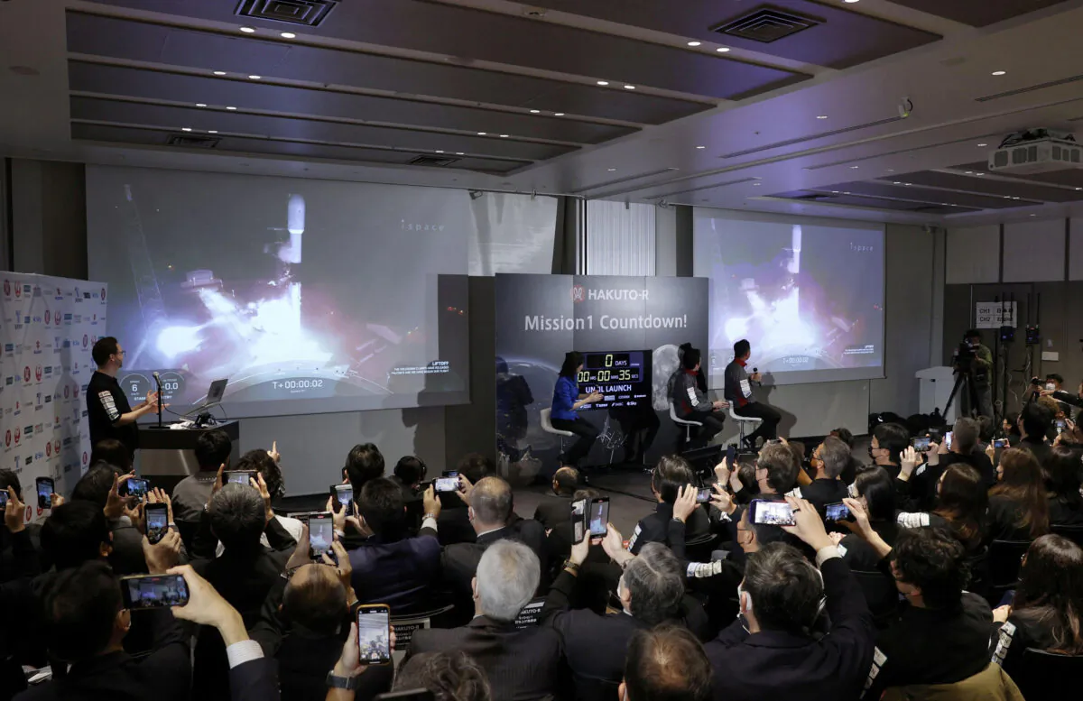Officials of ispace Inc.'s HAKUTO-R mission look at live broadcasting of the launch of a SpaceX Falcon 9 rocket for ispace at Cape Canaveral Space Force Station in Tokyo on Dec. 11, 2022. (Kyodo via Reuters)