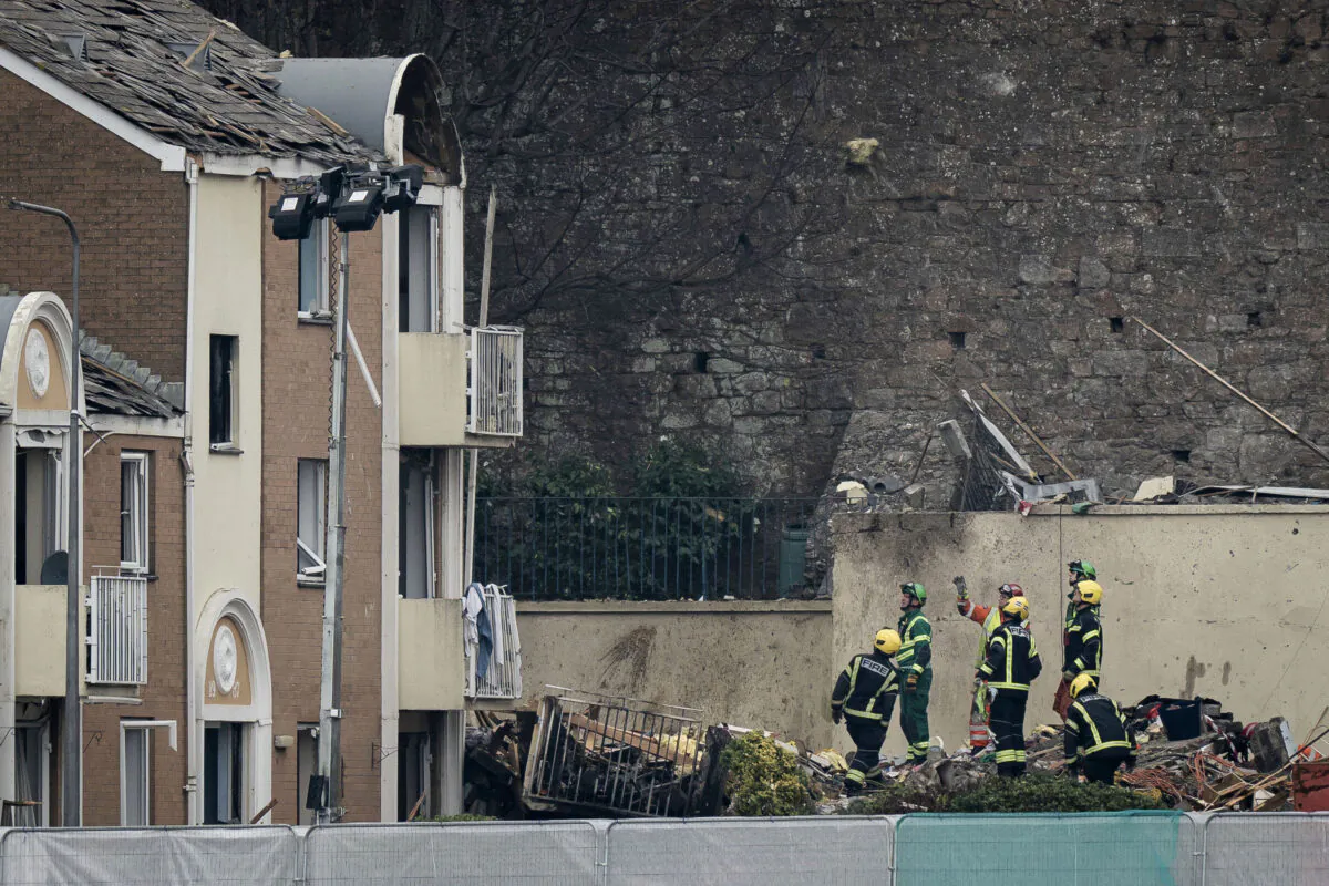 Specialist rescue teams at the scene of an explosion and fire at an apartment building in St Helier, Jersey, Channel Islands, on Dec. 11, 2022. (Aaron Chown/PA via AP)