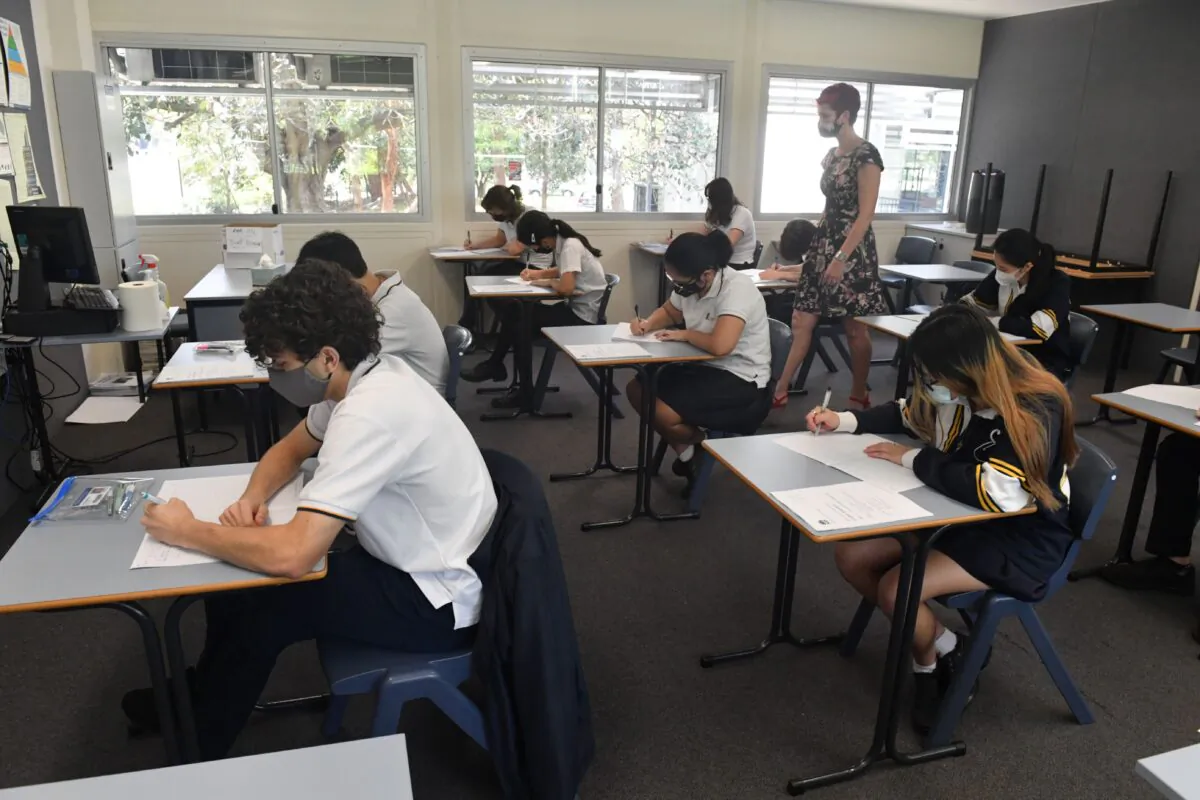 Year 12 students pose for a media opportunity following their first HSC exam at Sydney Secondary College in Sydney, Australia, on Nov. 9, 2021. (AAP Image/Mick Tsikas)