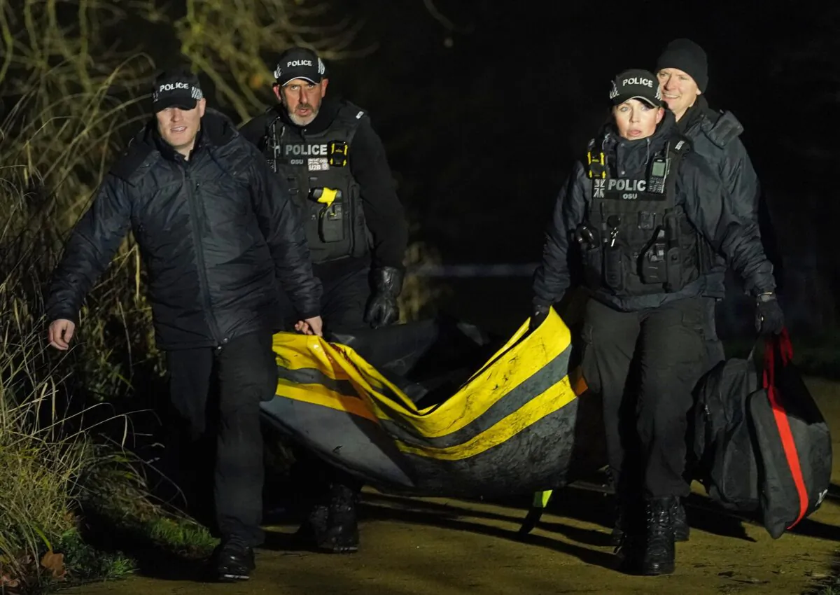 Emergency personnel at the scene in Solihull, England after several children fell into a frozen lake on Dec. 11, 2022. (Jacob King/PA)