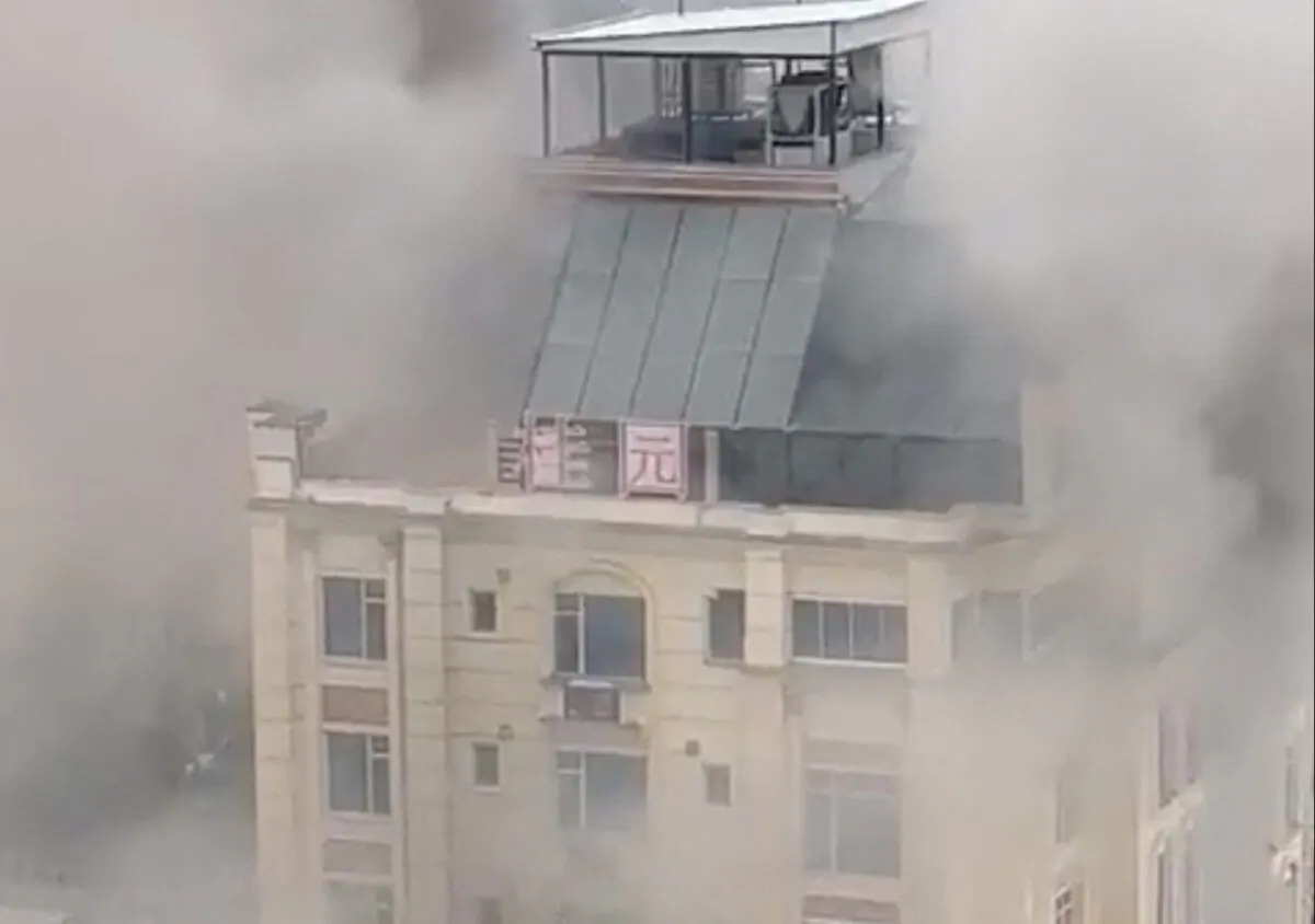 A hotel fire in Shahr-e-Naw neighborhood where gunfire was also heard, in Kabul, Afghanistan on Dec. 12, 2022, in a still from video. (Social media video via Reuters)