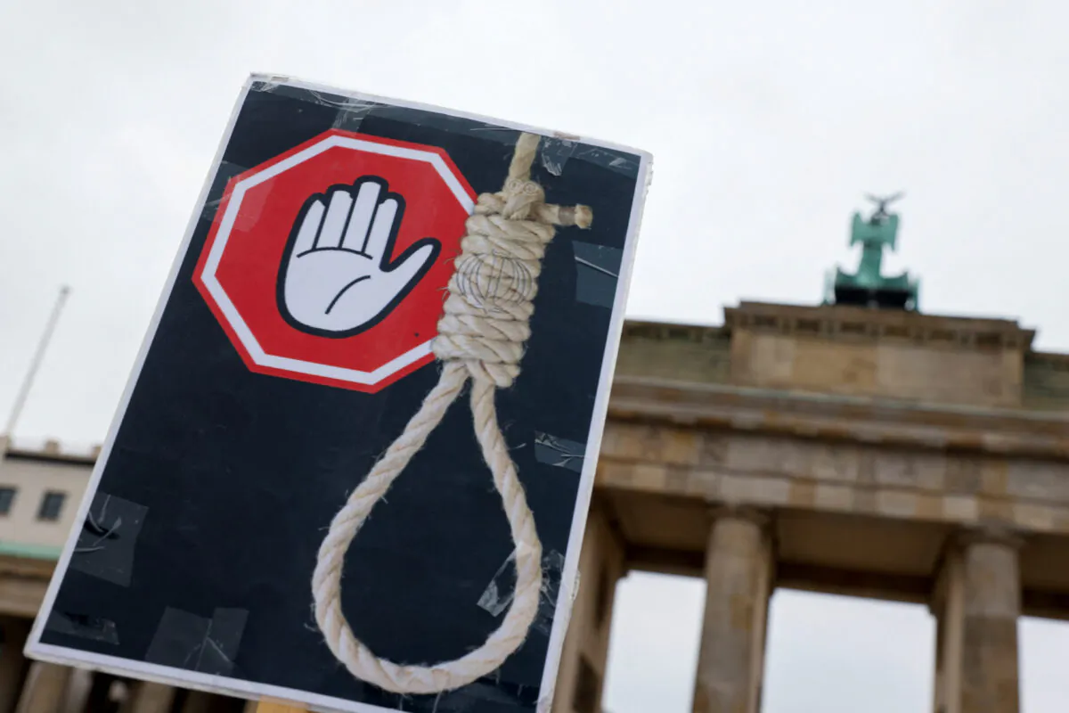 A placard during a protest against the Islamic regime of Iran following the death of Mahsa Amini in Berlin on Dec. 10, 2022. (Michele Tantussi/Reuters)