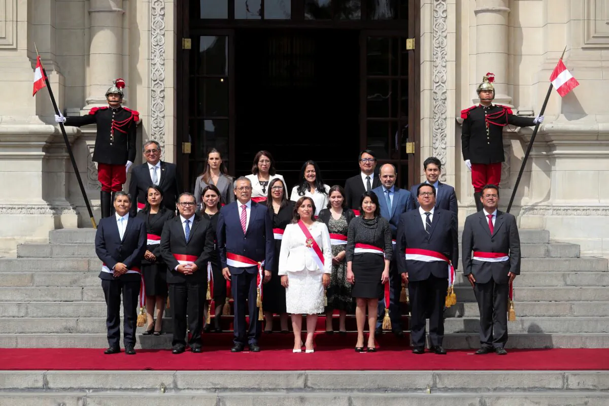 Peru's President Dina Boluarte, who took office after her predecessor Pedro Castillo was ousted, poses along with her new Cabinet in Lima, Peru, on Dec. 10, 2022. (Sebastian Castaneda/Reuters)