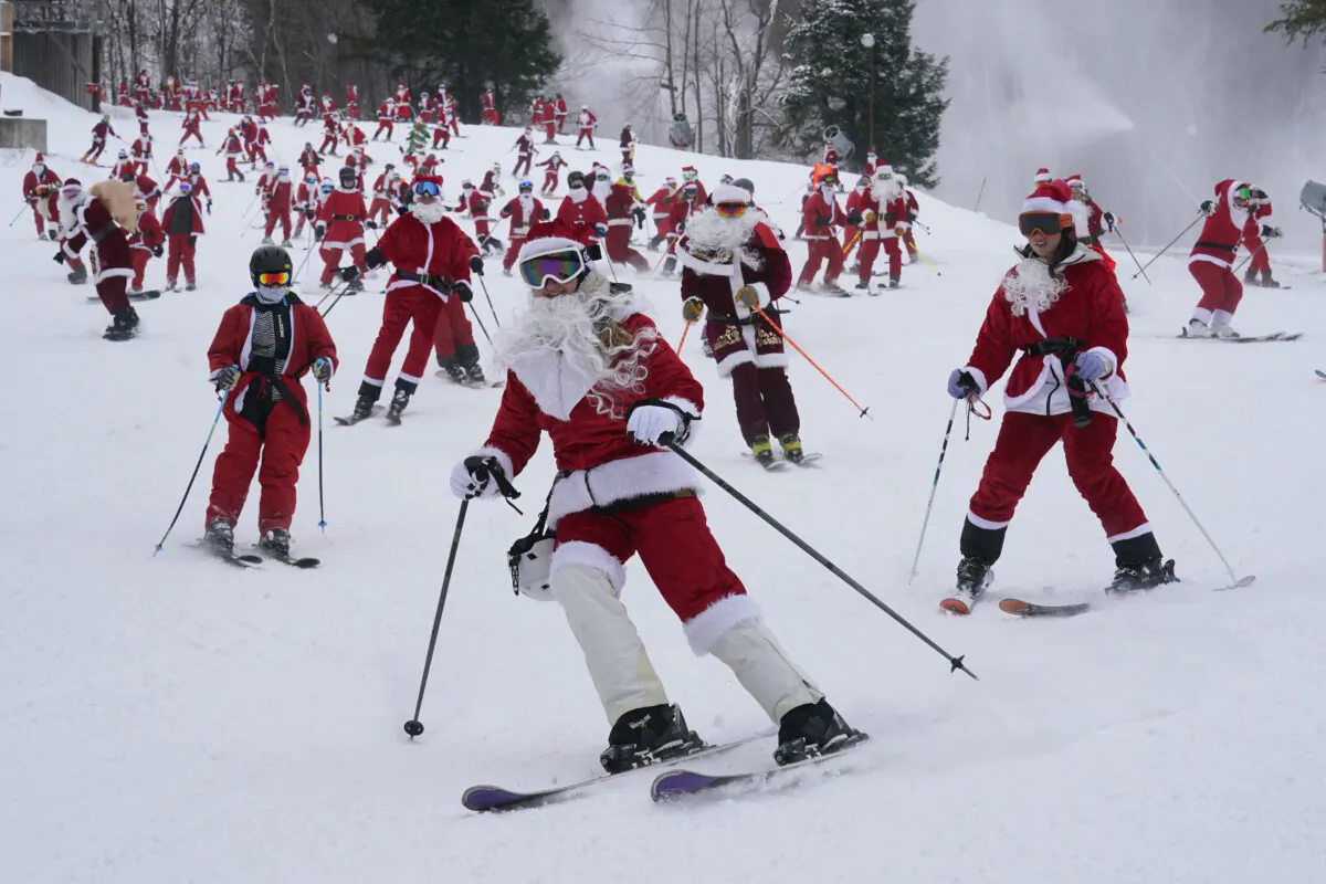 Skiers dressed in Santa Claus outfits hit the slopes for charity at the Sunday River Ski Resort in Newry, Maine, on Dec. 11, 2022. (Robert F. Bukaty/AP Photo)