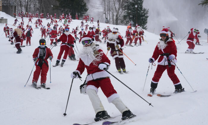 Skiers dressed in Santa Claus outfits hit the slopes for charity at the Sunday River Ski Resort in Newry, Maine, on Dec. 11, 2022. (Robert F. Bukaty/AP Photo)