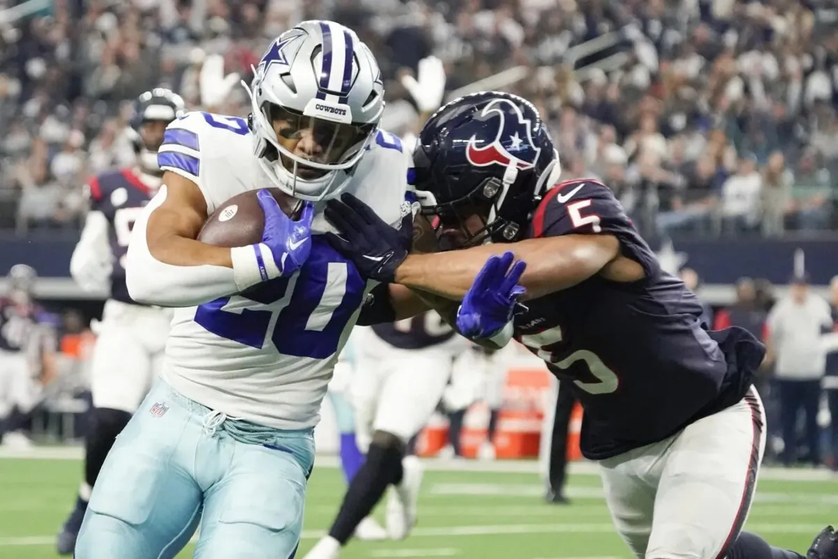 Dallas Cowboys running back Tony Pollard (20) runs past Houston Texans safety Jalen Pitre (5) for a 11-yard touchdown during the first half at AT&T Stadium in Arlington, Texas, on Dec. 11, 2022. (Raymond Carlin III/USA TODAY Sports via Field Level Media)