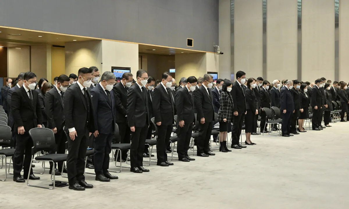 Hong Kong government, the Principal Officials, Members of the Executive Council, and directorate officers of bureaux and departments observing three minutes of mourning for Jiang Zemin on Dec. 6, 2022. (Government of Hong Kong Press Release)