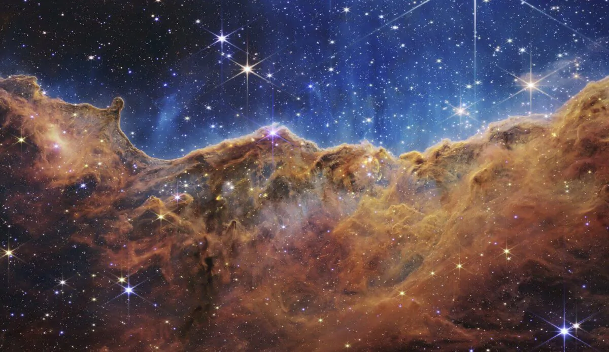 This image released by NASA on Tuesday, July 12, 2022, shows the edge of a nearby, young, star-forming region NGC 3324 in the Carina Nebula. Captured in infrared light by the Near-Infrared Camera (NIRCam) on the James Webb Space Telescope, this image reveals previously obscured areas of star birth, according to NASA. (The Canadian Press/NASA, ESA, CSA, and STScI via AP)
