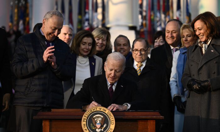 President Joe Biden signs the Respect for Marriage Act on the South Law of the White House on Dec. 13, 2022. (Brendan Smialowski/AFP via Getty Images)