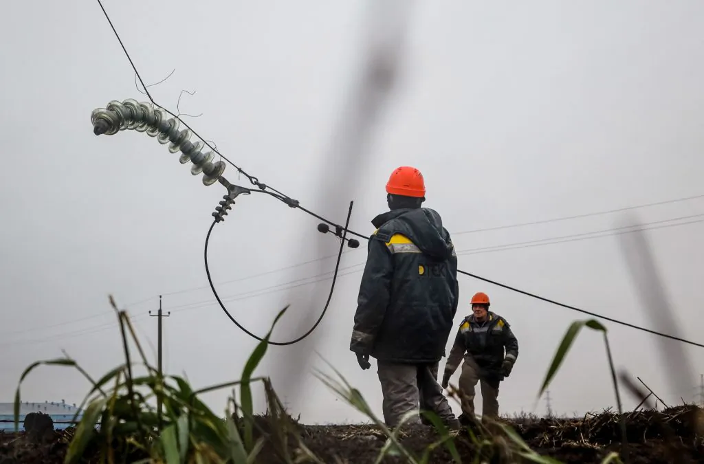 Workers repair high-voltage power lines cut by recent missile strikes near Odessa on Dec. 7, 2022, amid the Russian invasion of Ukraine. (Photo by Oleksandr Gimanov/AFP via Getty Images)