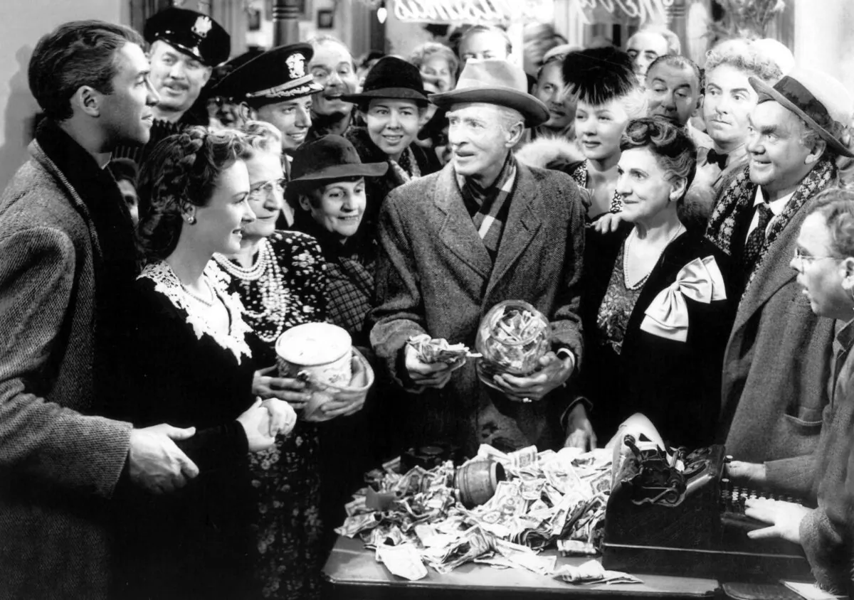 George
(leftmost), realizing
that heaven put
everyone on earth
for a purpose,
revels in his town’s
goodwill. (MovieStillDB)