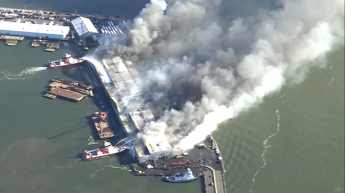Firefighters battle a blaze at a warehouse in the Brooklyn Borough of New York on Dec. 13, 2022. (WABC via AP)