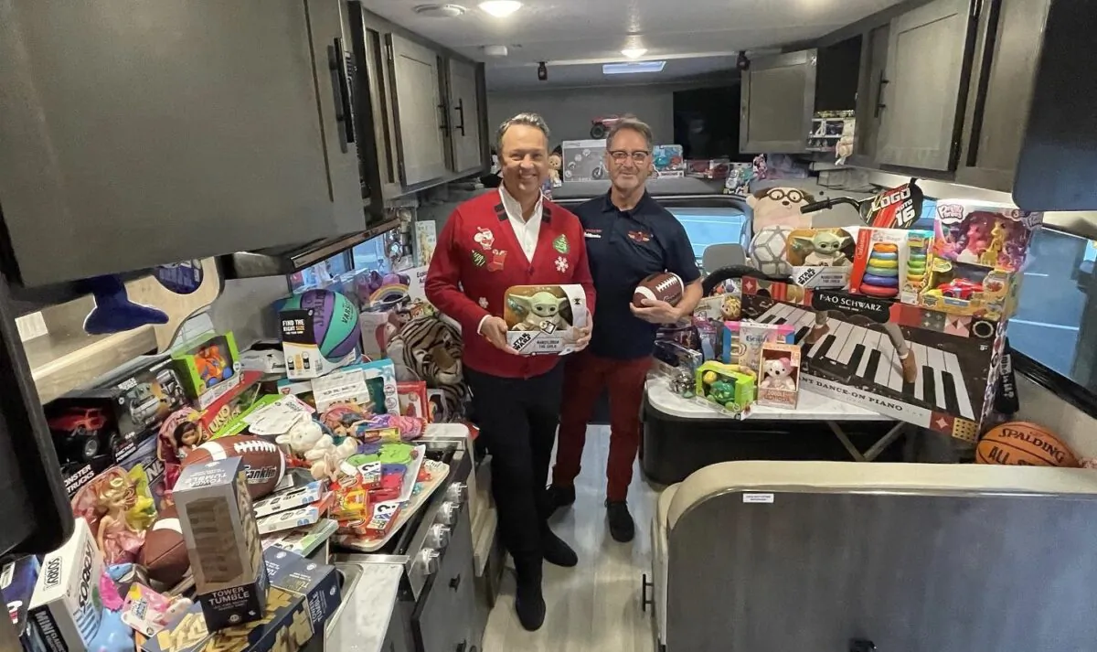 George Pennacchio (L) of KABC and Tom Wigginton (R) of El Monte RV are seen at the KABC's Stuff-a-Bus in Cerritos, Calif., on Dec. 9, 2022. (Courtesy of El Monte RV)