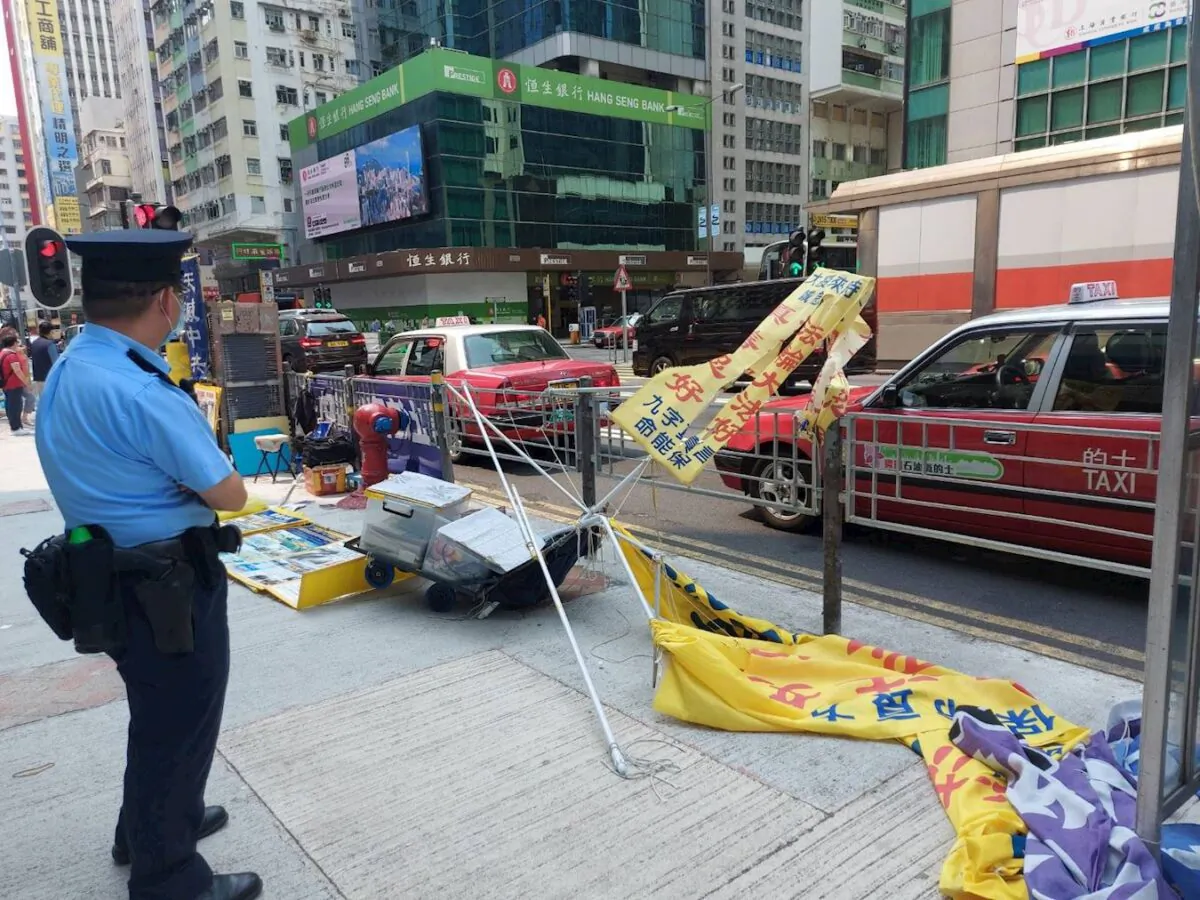 A Falun Gong information site in Mong Kok was damaged by vandals on April 2, 2021. (Chow Lei/The Epoch Times)