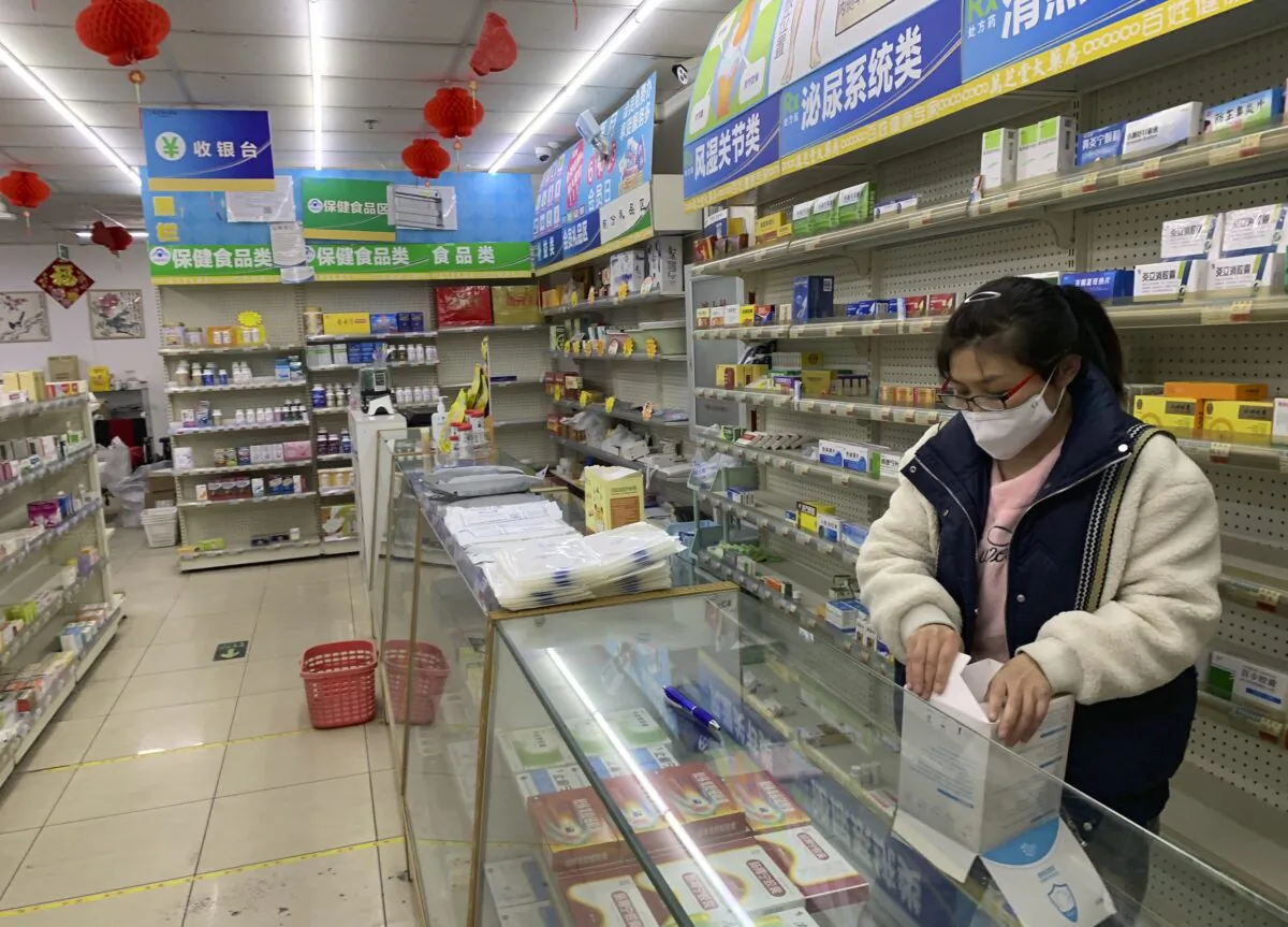 A pharmacist prepares medication for sale at a pharmacy in Beijing on Dec. 14, 2022. (Dake Kang/AP Photo)