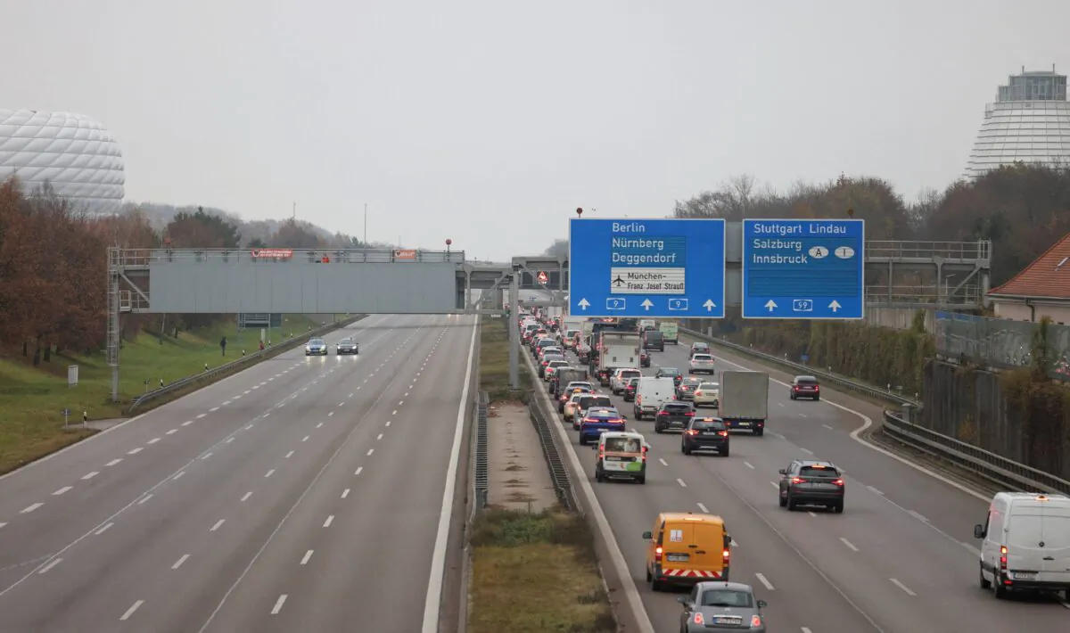 Police respond below as protesters sit on various A9 motorway sign-board structures with messages to reduce the speed limit on highways as well as for affordable public transport, outside Munich, Germany, on Dec. 5, 2022. (Lukas Barth/File Photo/Reuters)