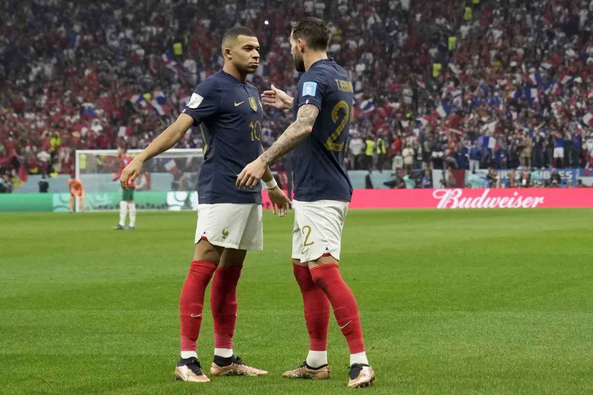 France's Theo Hernandez (R) celebrates with Kylian Mbappe after scoring the opening goal during the World Cup semifinal soccer match between France and Morocco at the Al Bayt Stadium in Al Khor, Qatar, on Dec. 14, 2022. (Christophe Ena/AP Photo)